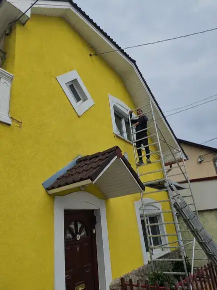 Sárga homlokzat festése állványról